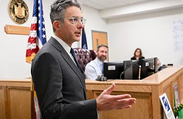 Judge speaking in a formal courtroom