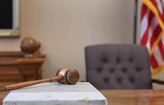 Photo of Judge's bench with gavel and american flag