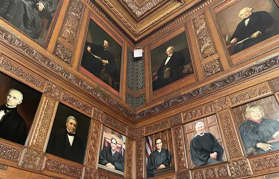 Two walls covered with portraits of judges from the Court of Appeals