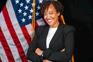 Photo of Zenith Taylor with American flag behind her