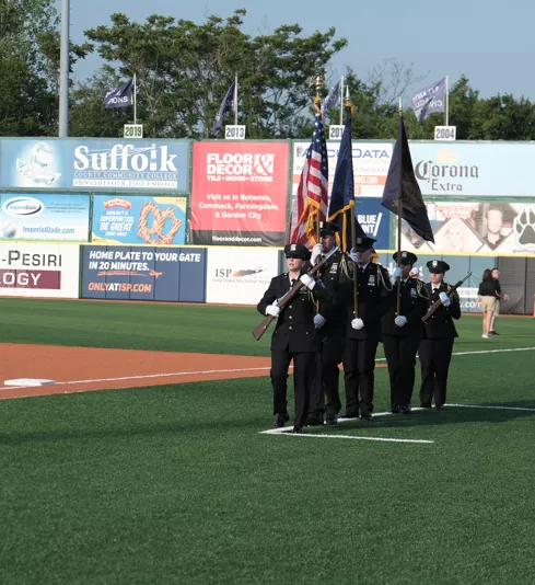The UCS Court Officer Ceremonial Unit marches onto the field to present the Colors 