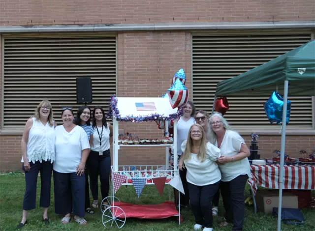 Staff from the District Court Clerk’s Office stand with their patriotic Cupcake Cart (L-R) Marie Ruller, Kelly Logiudice, Cheyanne Romero, Kristina Kahres, Eileen Minutoli, Caitlin Hunt, Lisa Downs, and at bottom right, Joanne McLaughlin