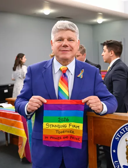 District Administrative Judge Andrew Crecca poses with his addition to the Suffolk County Courts Pride Quilt 